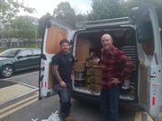 image of workers loading a van with food boxes ready to be delivered